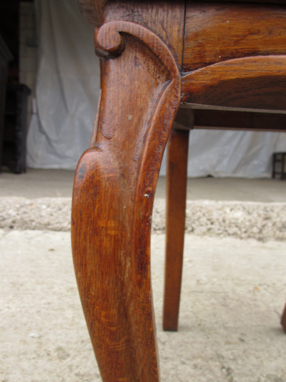 A pair of Victorian carved golden oak hall chairs featuring openwork shield backs with central cartouches, solid wooden seats, and cabriole front legs. View XII