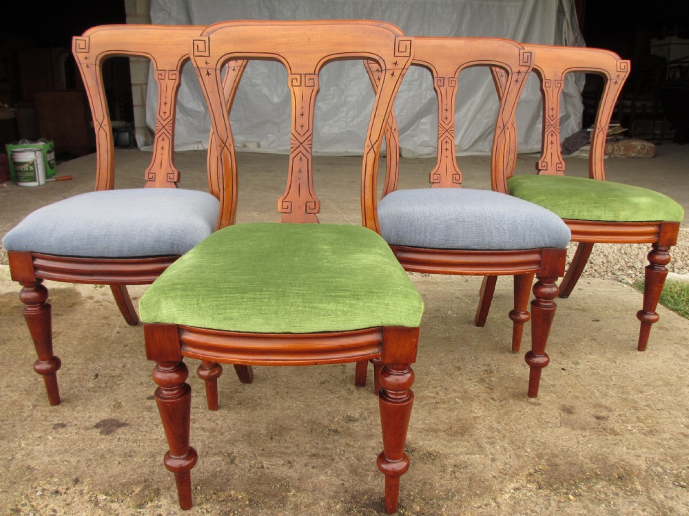 A set of four antique mahogany dining chairs with carved vase splats, inlaid details, turned front legs, and fabric drop-in seats. View II