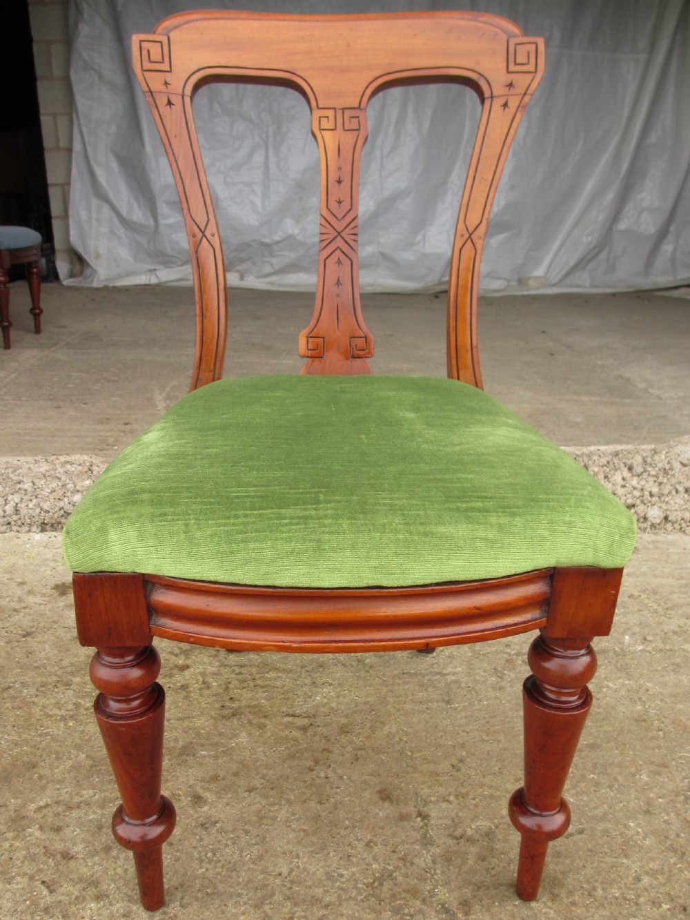 A set of four antique mahogany dining chairs with carved vase splats, inlaid details, turned front legs, and fabric drop-in seats. View III