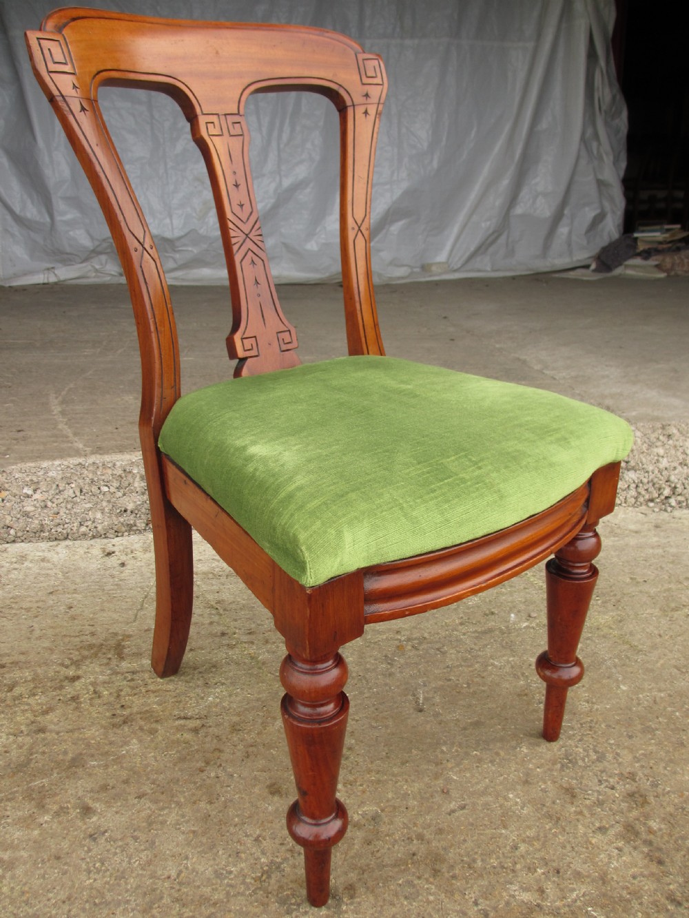 A set of four antique mahogany dining chairs with carved vase splats, inlaid details, turned front legs, and fabric drop-in seats. View IV