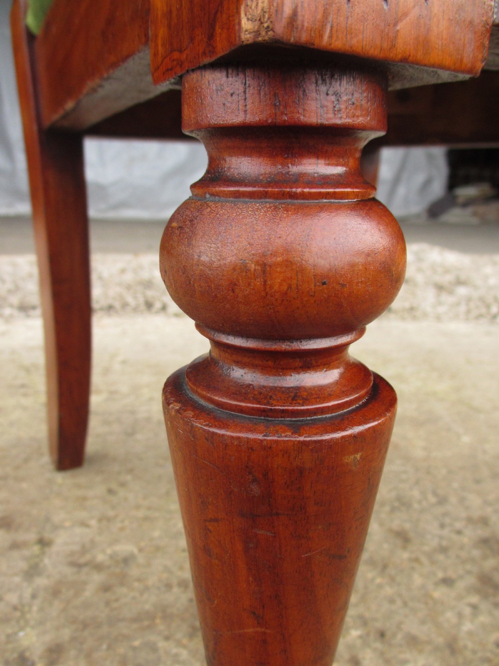 A set of four antique mahogany dining chairs with carved vase splats, inlaid details, turned front legs, and fabric drop-in seats. View X