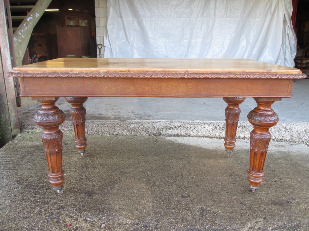 Victorian carved oak dining table with bulbous carved and tapering fluted legs on castors View II