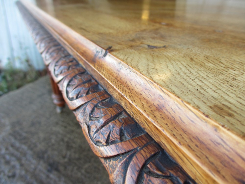 Victorian carved oak dining table with bulbous carved and tapering fluted legs on castors View III