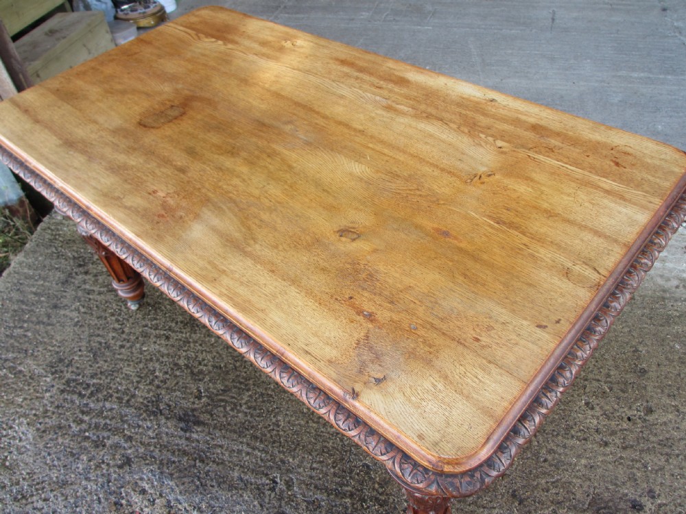 Victorian carved oak dining table with bulbous carved and tapering fluted legs on castors View IV