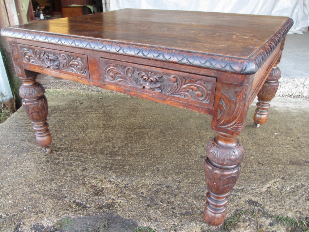 Victorian carved oak green man library writing desk twin drawers carved legs on castors with stops View III