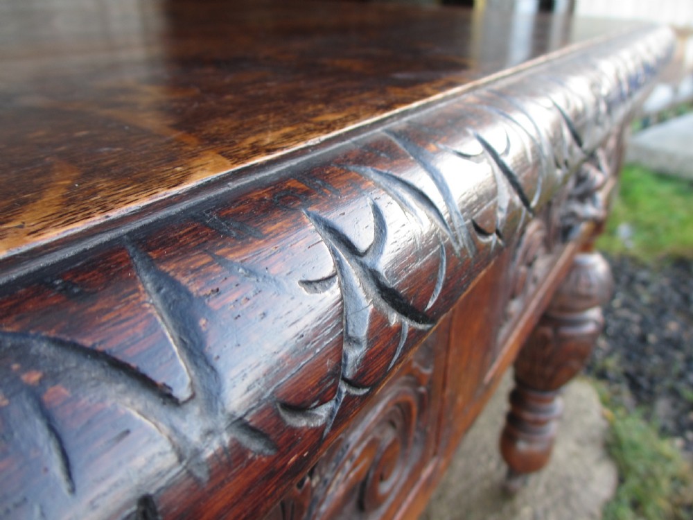Victorian carved oak green man library writing desk twin drawers carved legs on castors with stops View VII