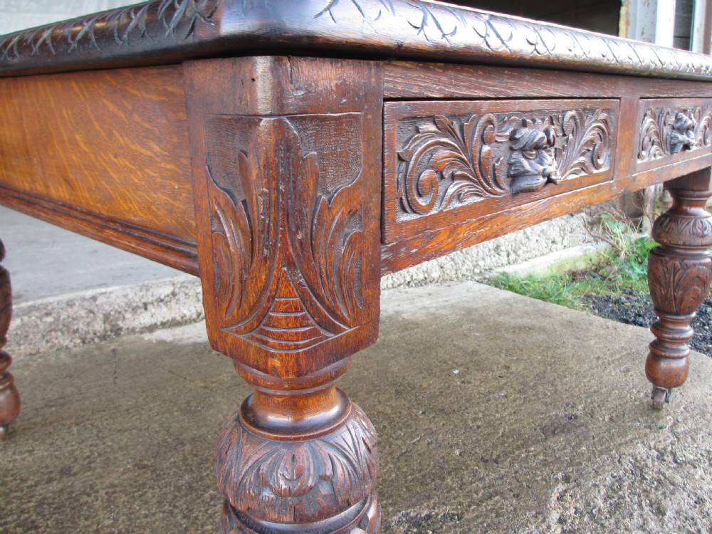 Victorian carved oak green man library writing desk twin drawers carved legs on castors with stops View IX