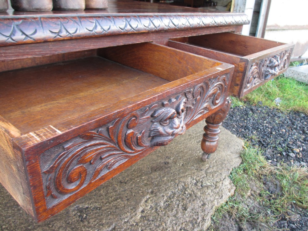 Victorian carved oak green man library writing desk twin drawers carved legs on castors with stops View XIV