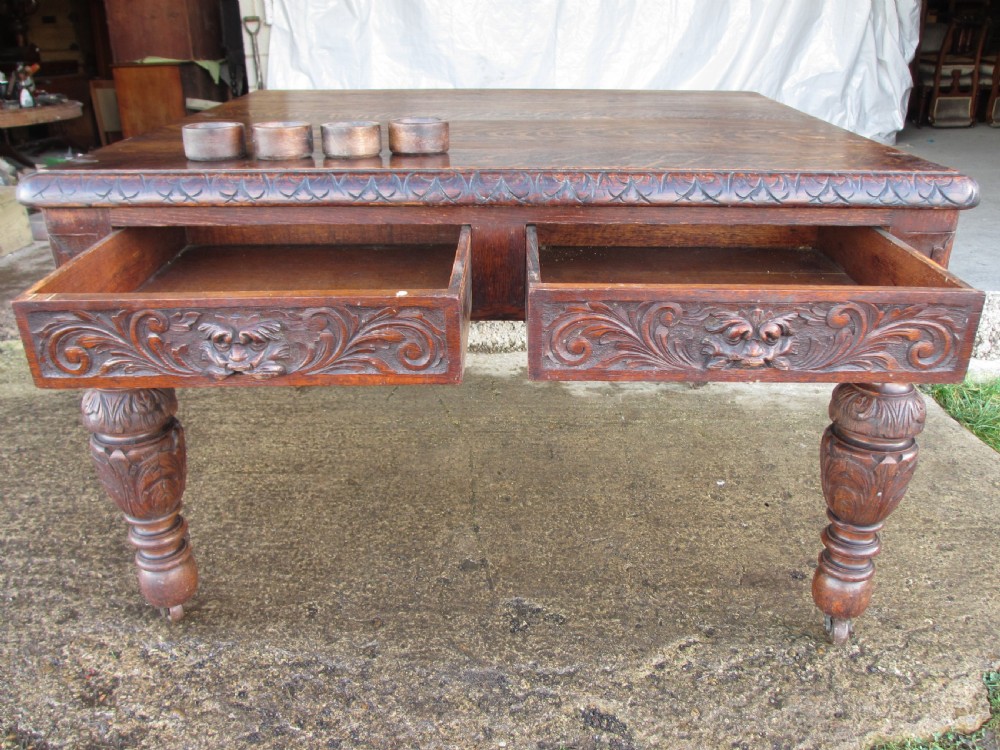 Victorian carved oak green man library writing desk twin drawers carved legs on castors with stops View XVI