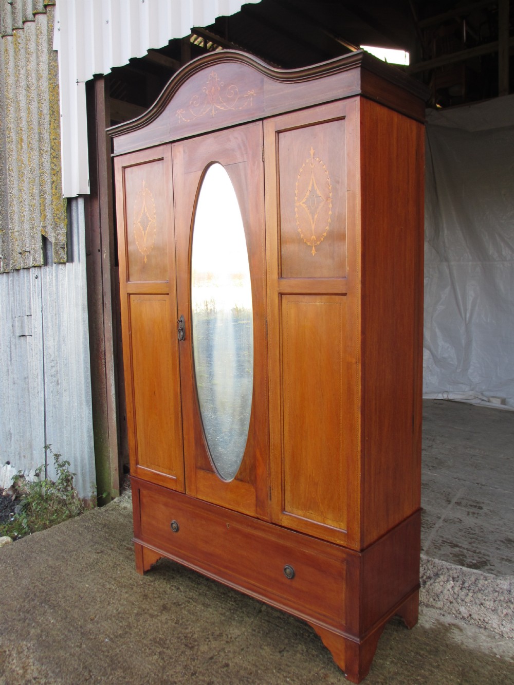 Edwardian Mahogany oval mirror inlaid single door wardrobe with key