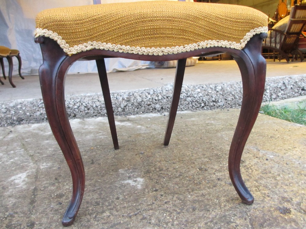A set of six Victorian rosewood balloon back dining chairs with carved waist rails, yellow upholstered serpentine seats, and cabriole legs. View VII