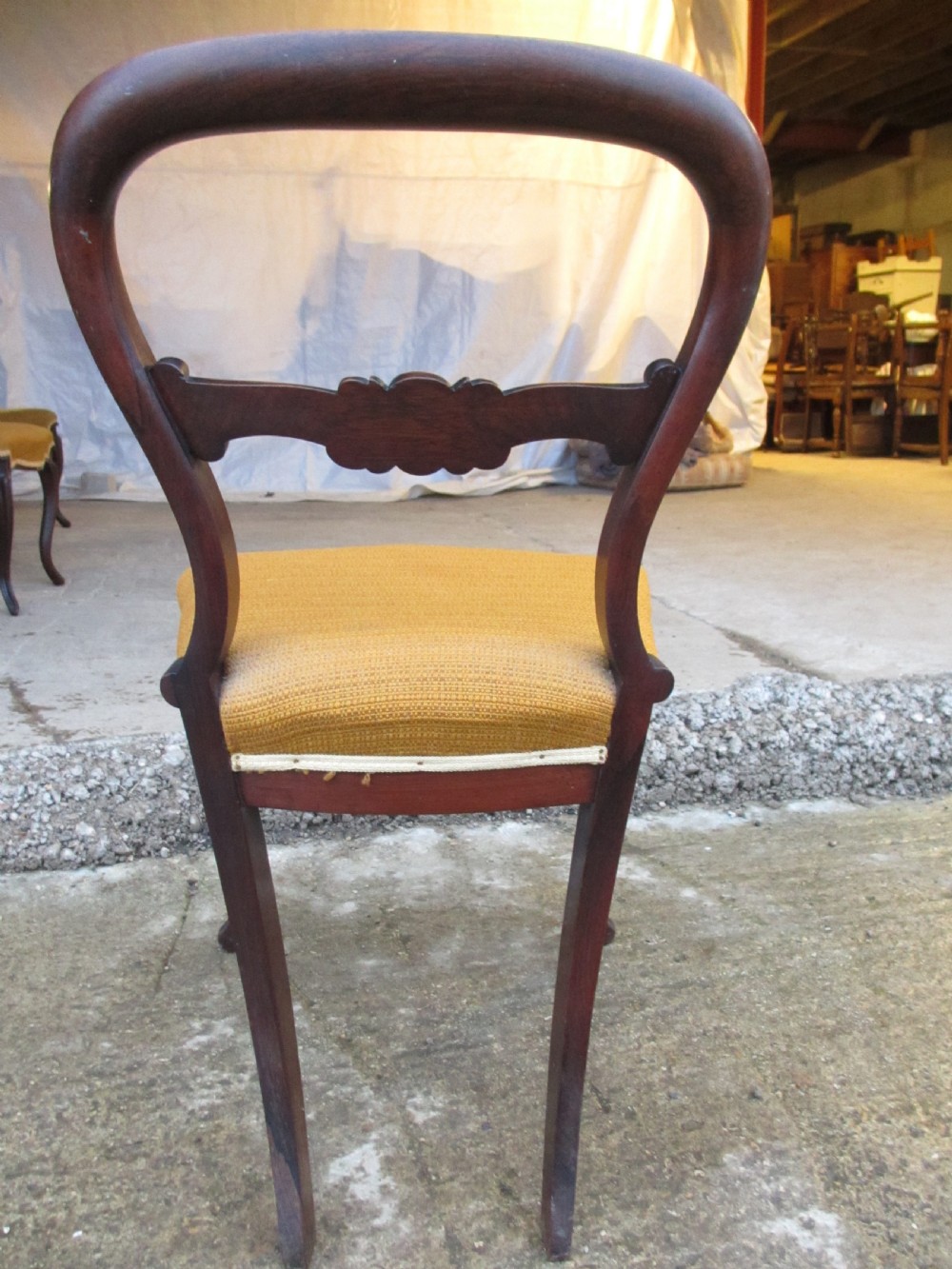 A set of six Victorian rosewood balloon back dining chairs with carved waist rails, yellow upholstered serpentine seats, and cabriole legs. View XIII