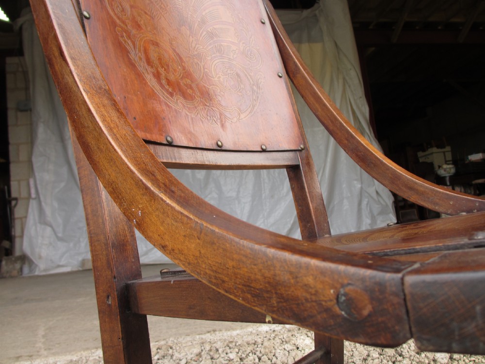 A Victorian oak and beech rocking chair featuring turned spindles, a carved shell pattern on the backrest and seat, and decorative metal studs. View VIII