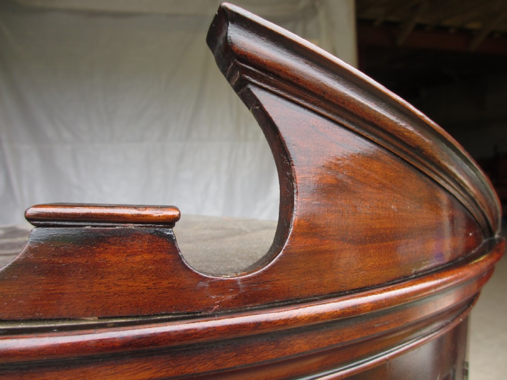 A two-piece flame mahogany corner cabinet featuring a broken pediment top, an upper glazed door, and a lower bow-front cupboard door supported by cabriole legs. View V