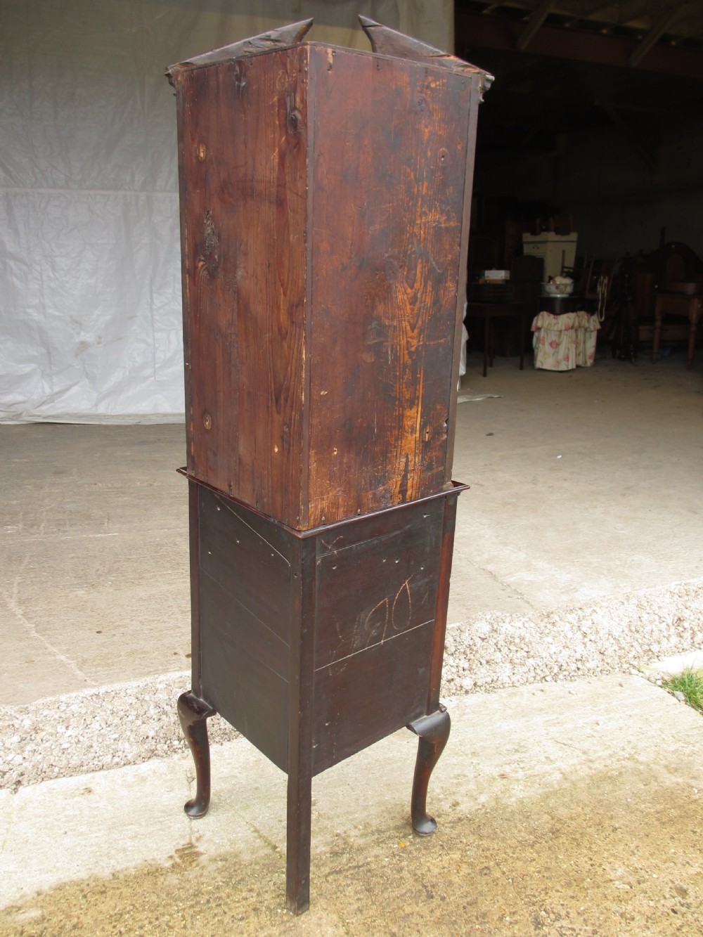 A two-piece flame mahogany corner cabinet featuring a broken pediment top, an upper glazed door, and a lower bow-front cupboard door supported by cabriole legs. View XI