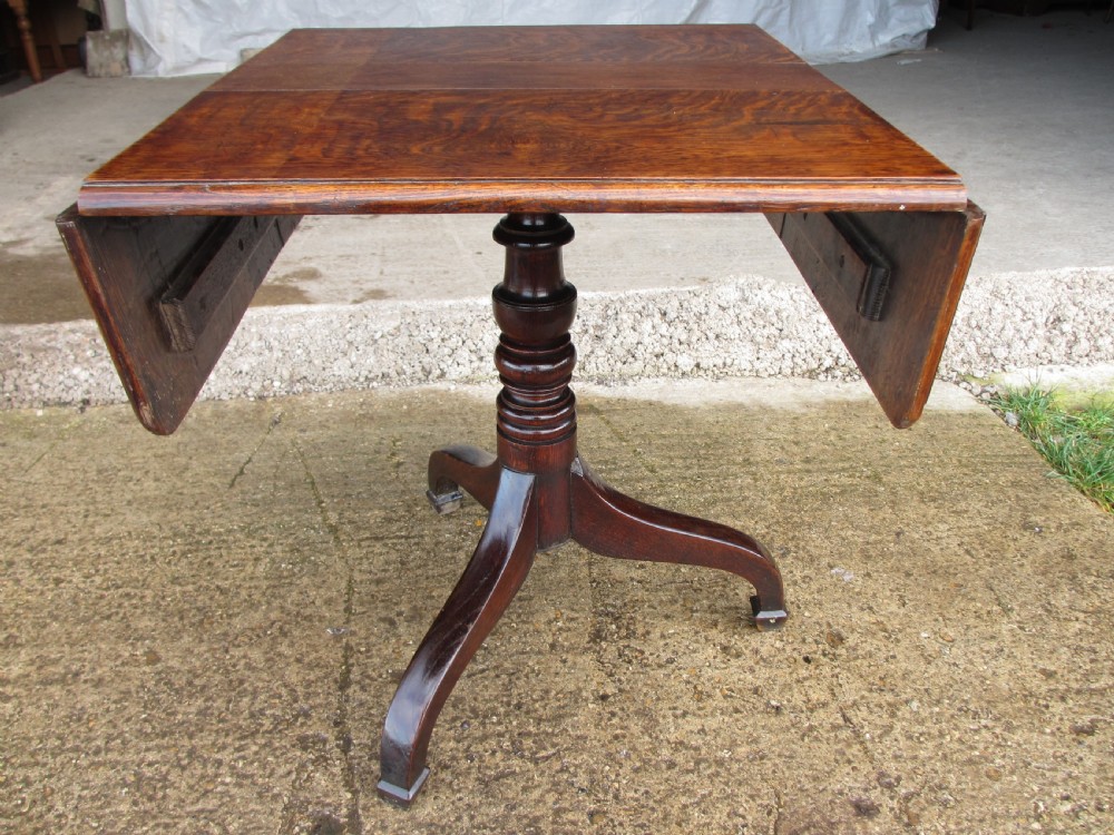 A Victorian dark oak drop-leaf breakfast table featuring a rectangular surface with grain figure, a turned central pedestal stem, and splayed legs. View II