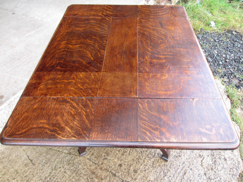 A Victorian dark oak drop-leaf breakfast table featuring a rectangular surface with grain figure, a turned central pedestal stem, and splayed legs. View VIII