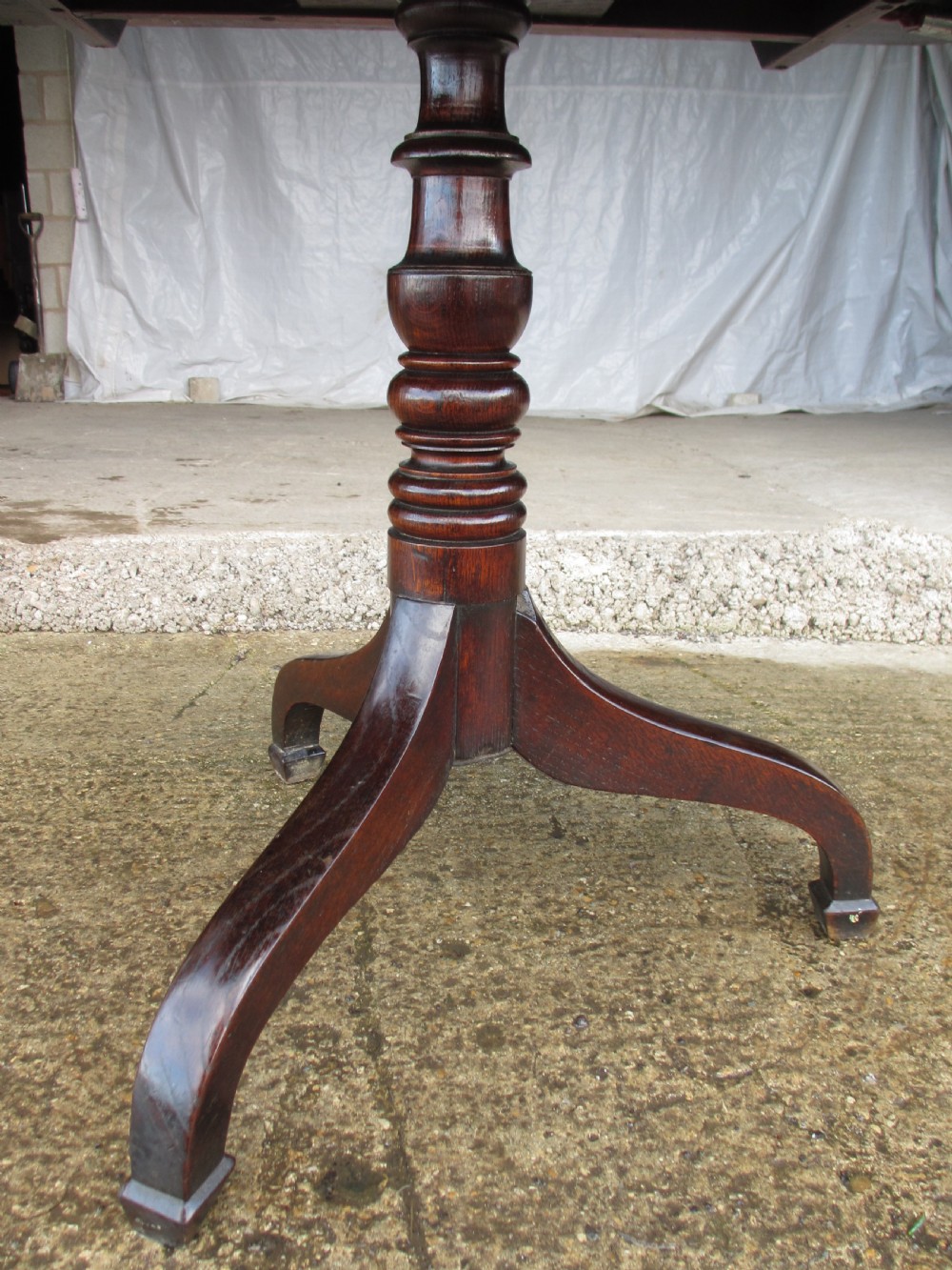 A Victorian dark oak drop-leaf breakfast table featuring a rectangular surface with grain figure, a turned central pedestal stem, and splayed legs. View X