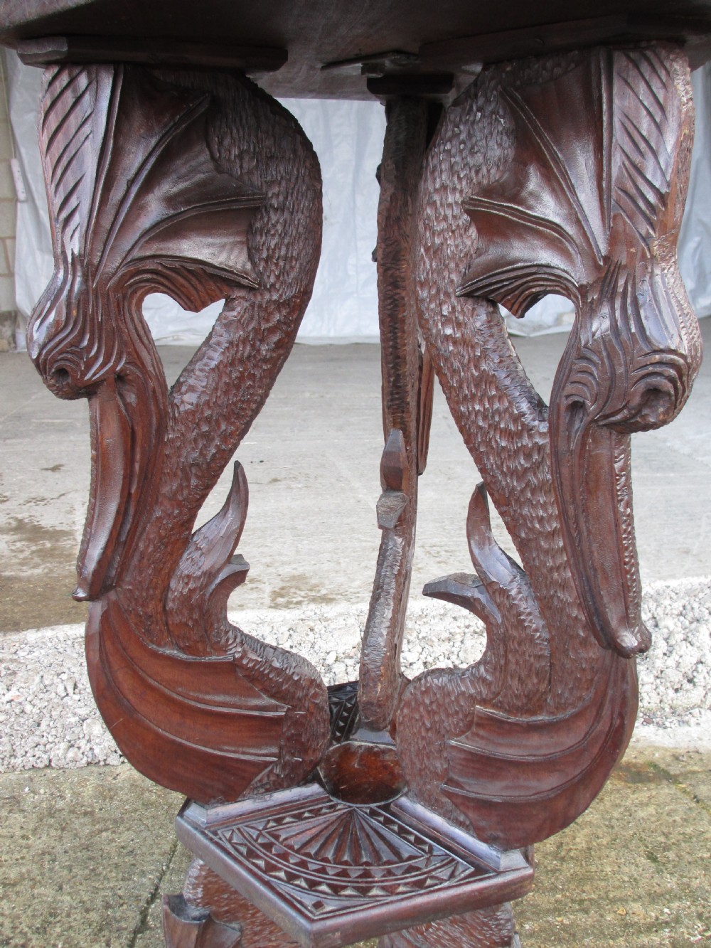 A Victorian Anglo-Burmese carved padouk wood and brass floor oil lamp with mythical dragon legs, a carved column, a brass reservoir, and a white glass shade. View IX