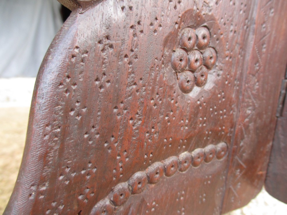 An Anglo-Indian carved teak occasional table with a scalloped circular top, floral inlay centre, and a folding fretted base. View IX