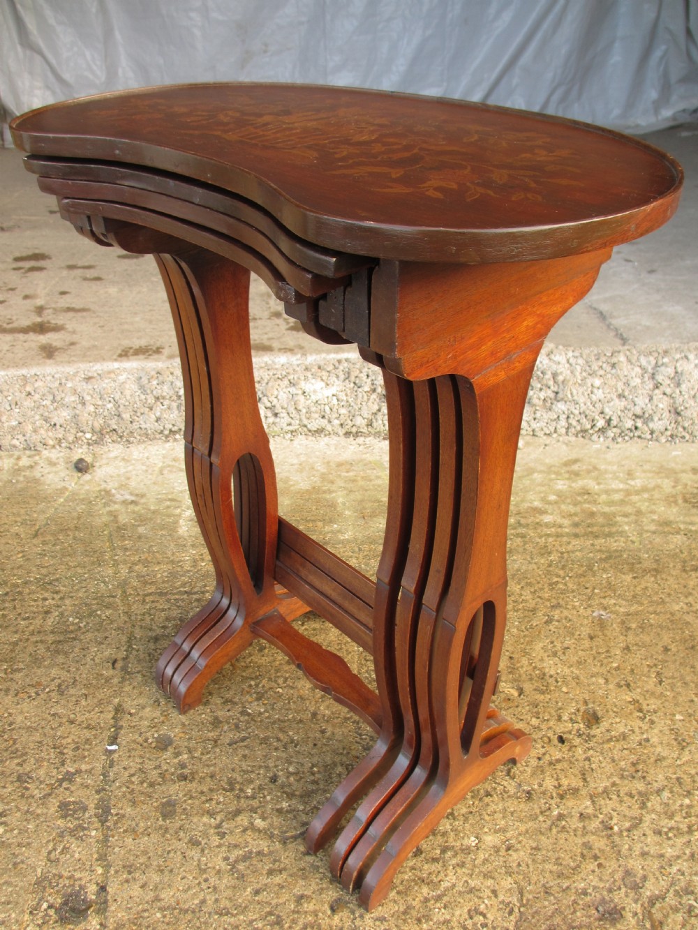 A set of four nested mahogany side tables featuring kidney-shaped tops with floral marquetry inlay. View III