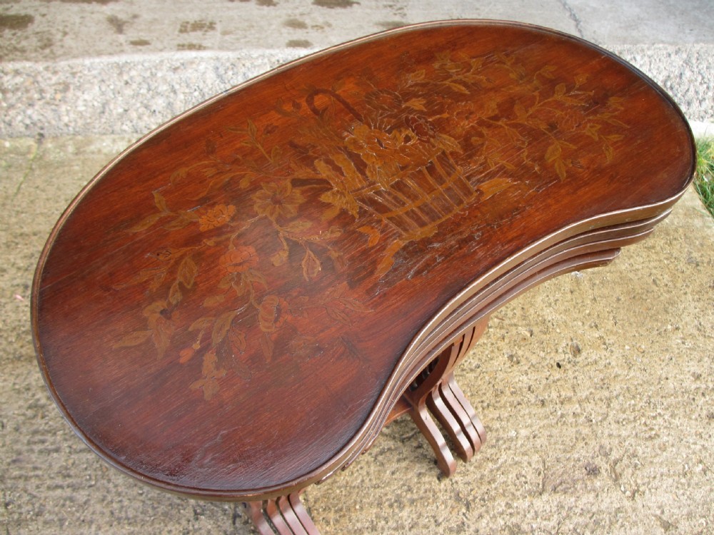 A set of four nested mahogany side tables featuring kidney-shaped tops with floral marquetry inlay. View IV