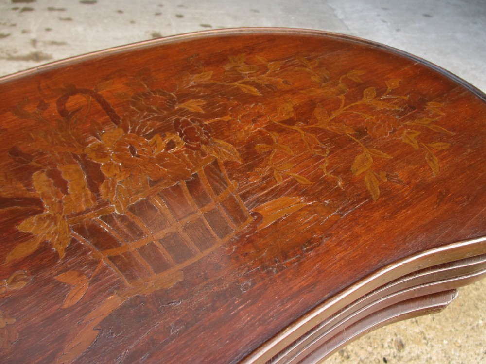 A set of four nested mahogany side tables featuring kidney-shaped tops with floral marquetry inlay. View V