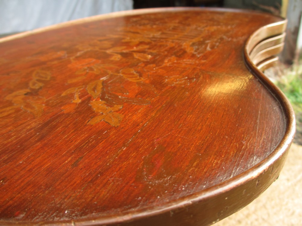 A set of four nested mahogany side tables featuring kidney-shaped tops with floral marquetry inlay. View VI