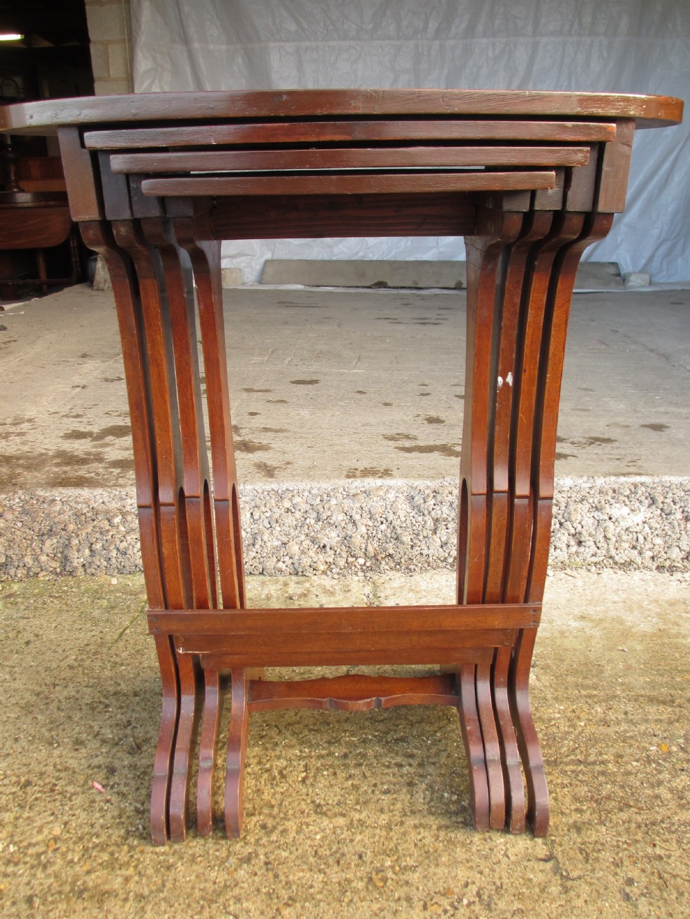 A set of four nested mahogany side tables featuring kidney-shaped tops with floral marquetry inlay. View XI