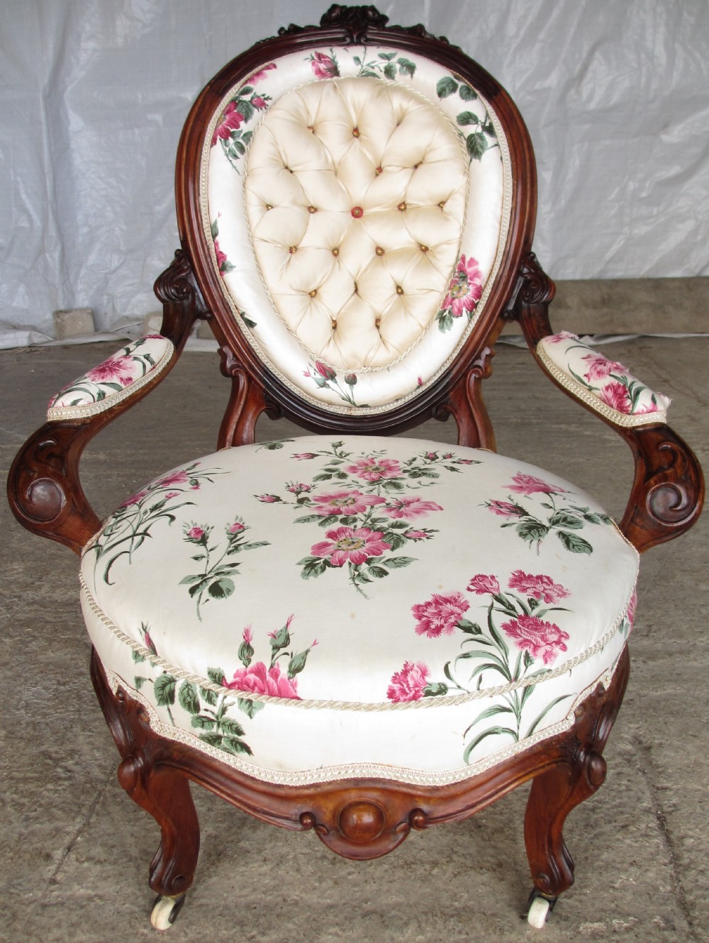 Early Victorian mahogany carved show wood button upholstered spoon back armchair