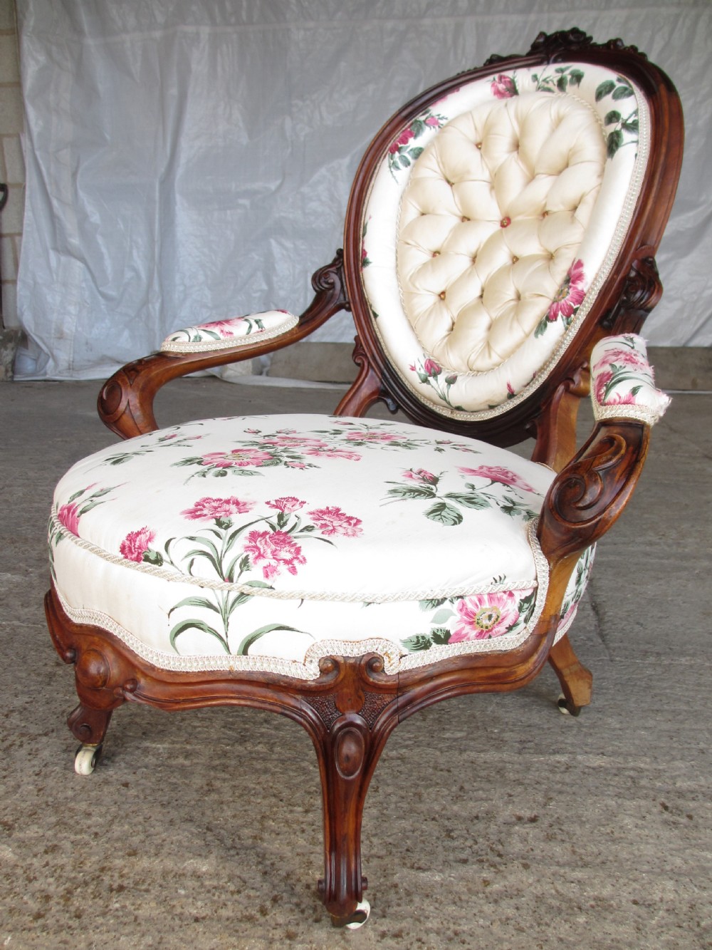 Early Victorian mahogany carved show wood button upholstered spoon back armchair View II