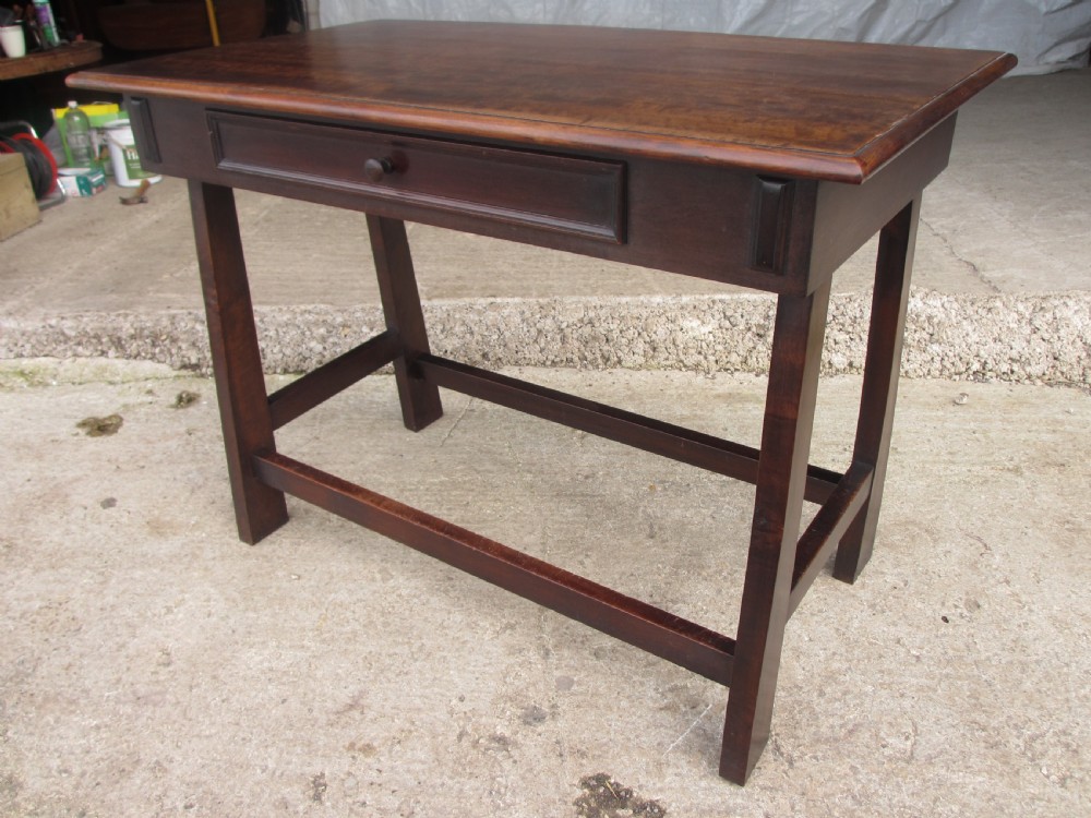 A dark mahogany wooden side table featuring a single frieze drawer with a wooden knob handle and lower cross stretchers. View III