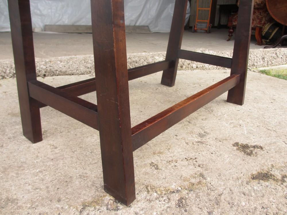A dark mahogany wooden side table featuring a single frieze drawer with a wooden knob handle and lower cross stretchers. View VII