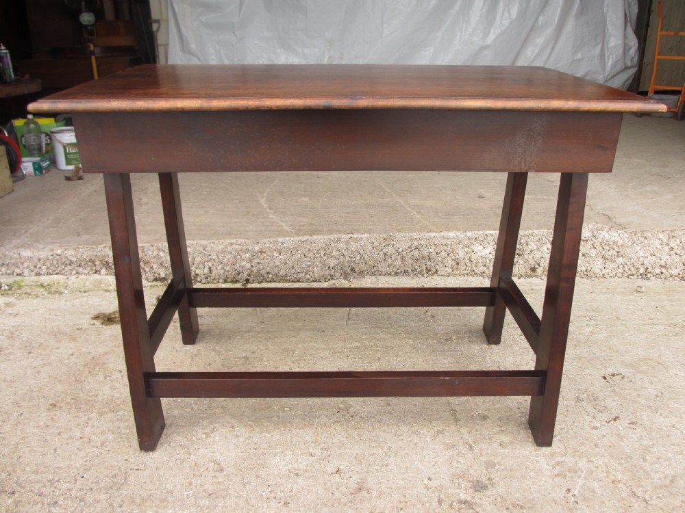 A dark mahogany wooden side table featuring a single frieze drawer with a wooden knob handle and lower cross stretchers. View XII