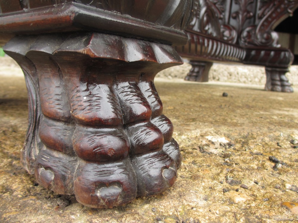 Carved dark mahogany centre console table featuring scroll supports with carved grotesque figures, a decorated stretcher, and claw feet. View VIII