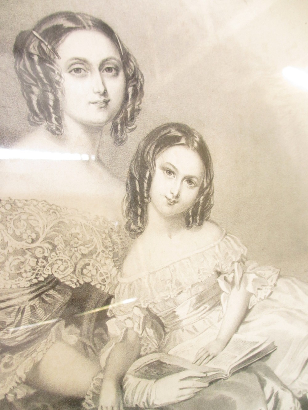 A rectangular gold gilt frame with ornate scroll detailing containing a monochrome portrait drawing of a mother and daughter. View VIII