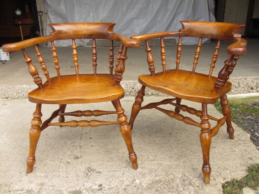 Pair of 19th century elm seated captain smokers bow arm chairs