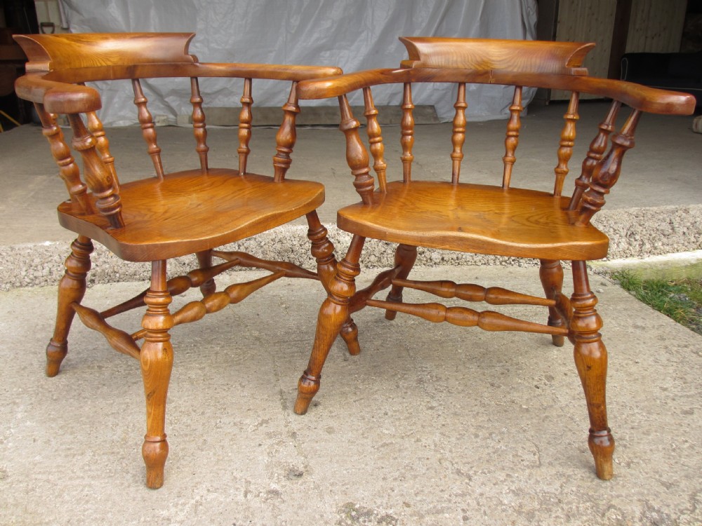 Pair of 19th century elm seated captain smokers bow arm chairs View II