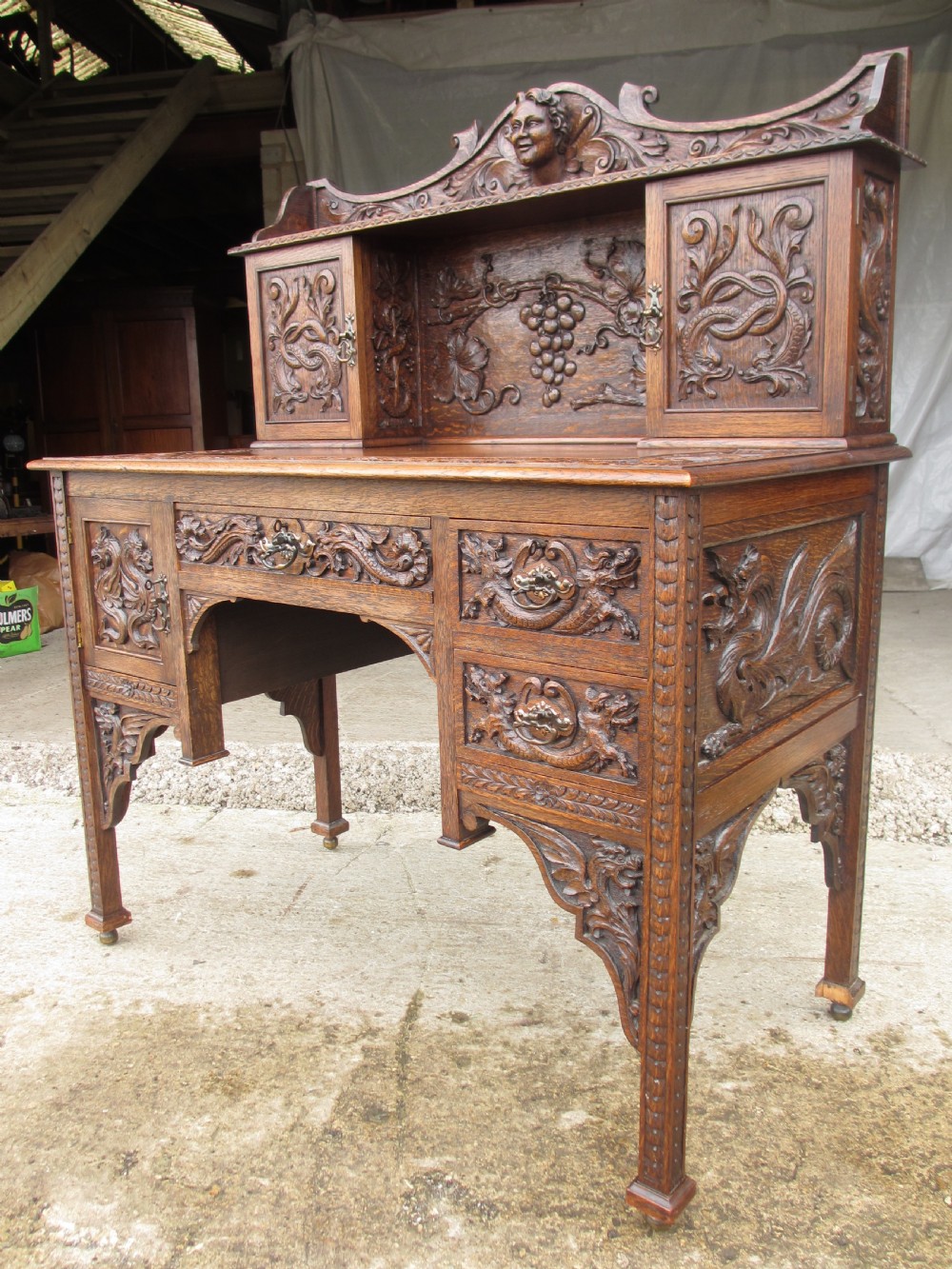 Unusual Victorian serpentine carved Oak writing desk View II