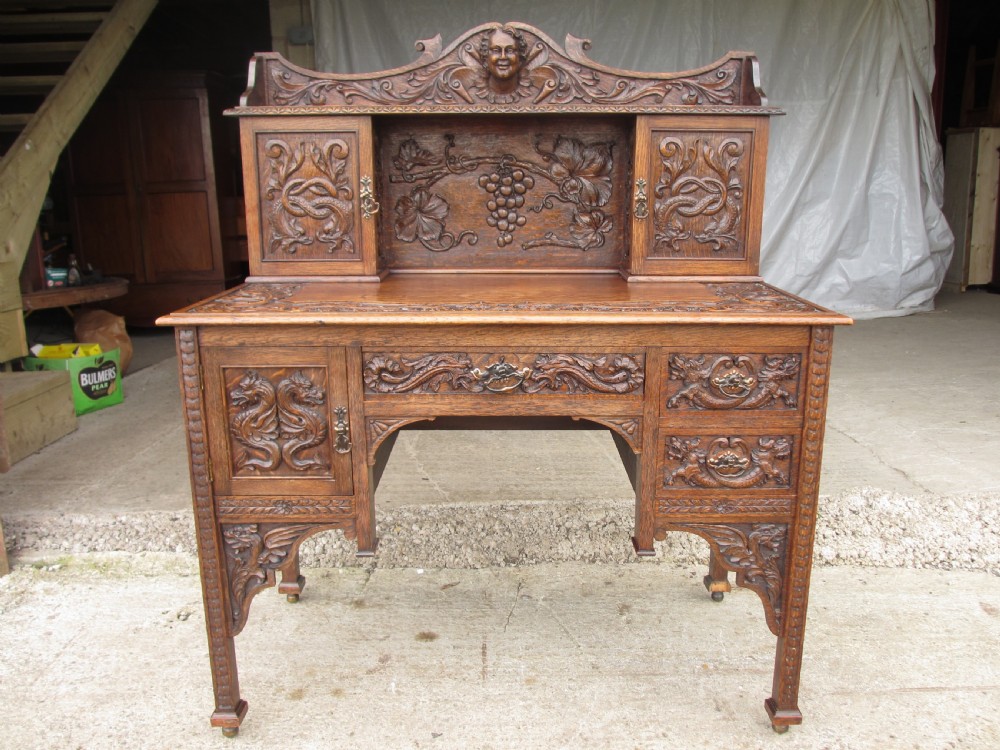 Unusual Victorian serpentine carved Oak writing desk