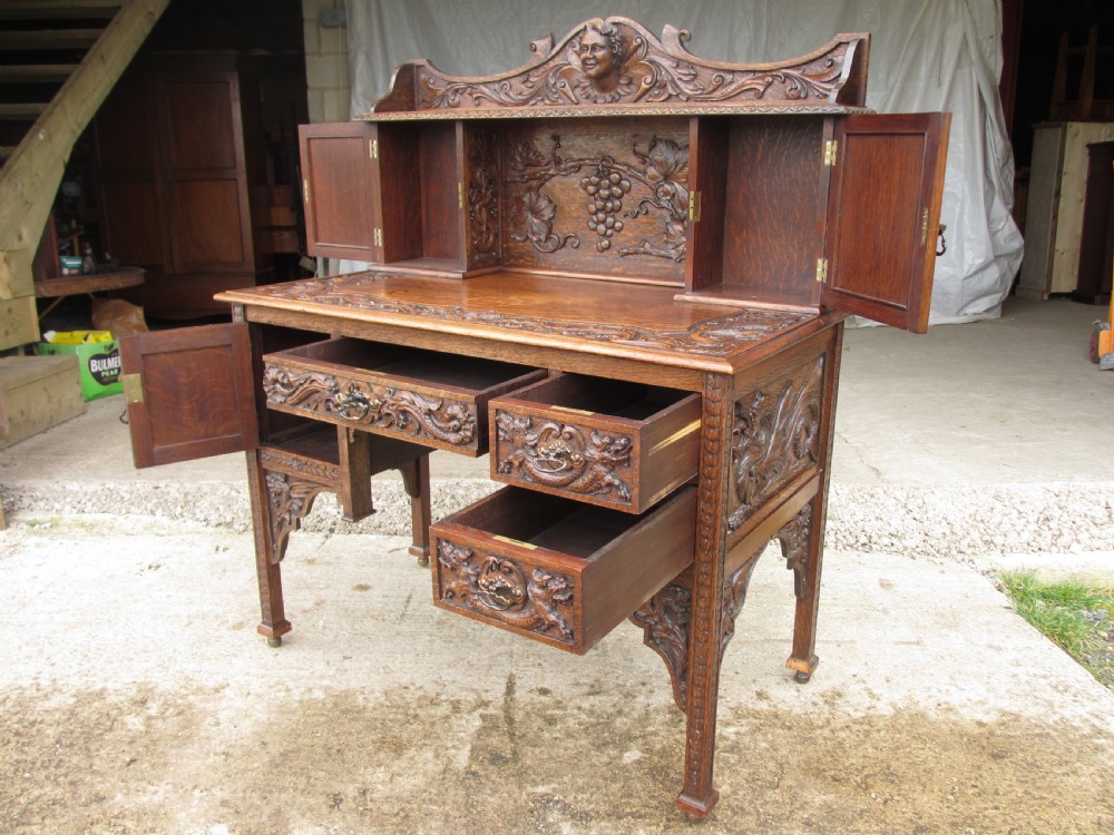 Unusual Victorian serpentine carved Oak writing desk View IX