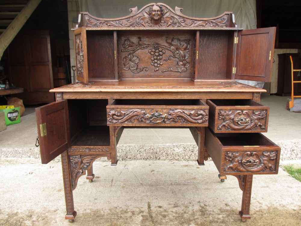 Unusual Victorian serpentine carved Oak writing desk View X