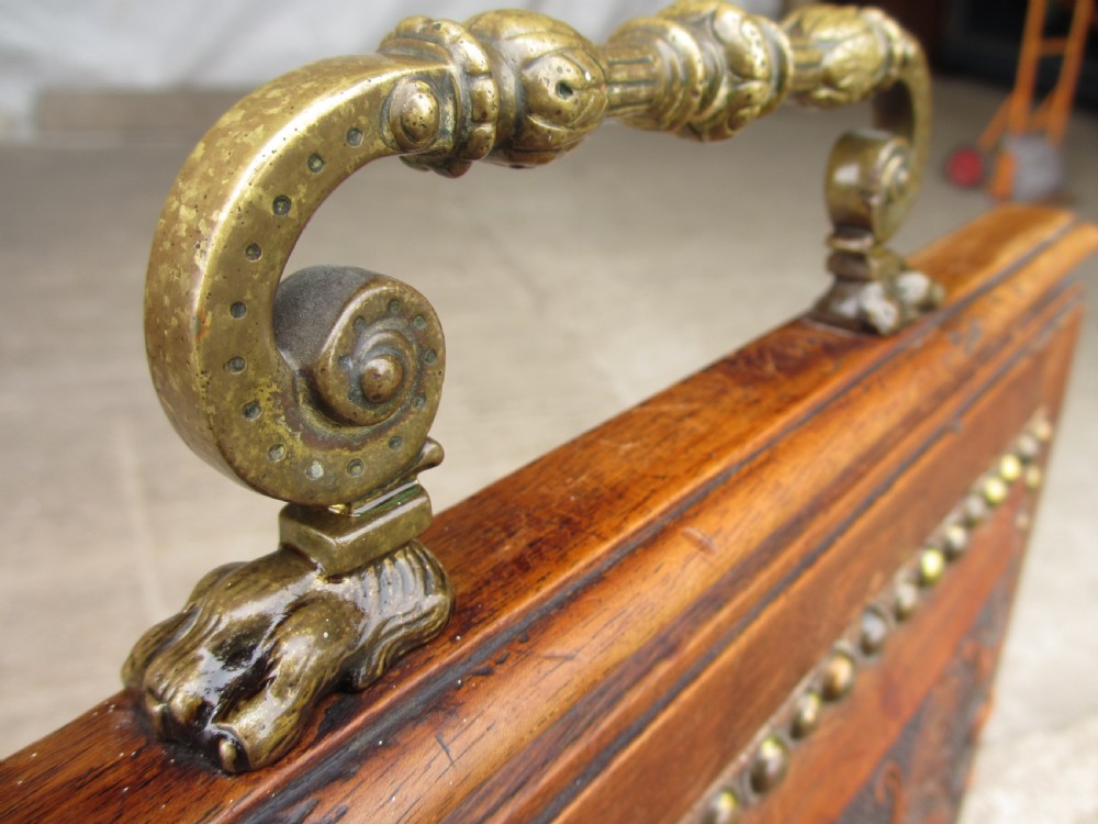 A set of Victorian dining chairs featuring embossed floral leather backrests and seats, brass top handles, turned front legs with castors, and studding detail. View X