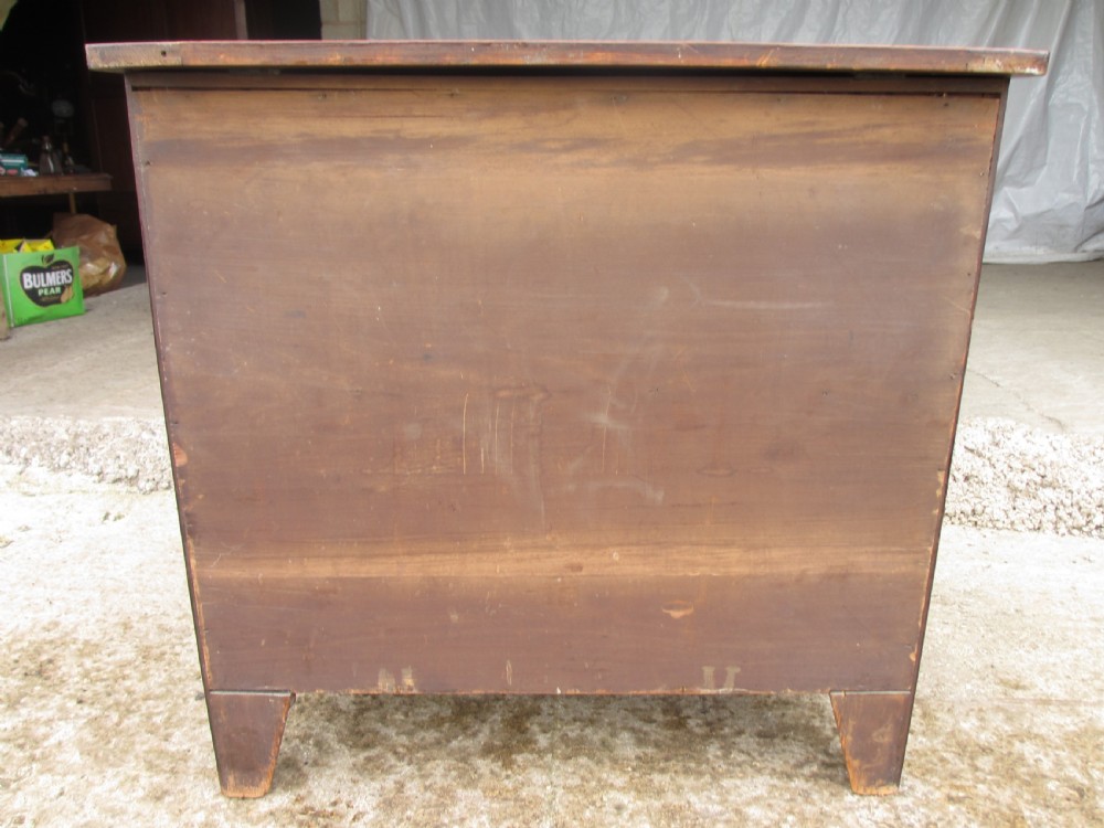 A Georgian flame mahogany bow-fronted pot commode featuring decorative string inlay, turned wooden knobs, and splayed bracket feet. View XII