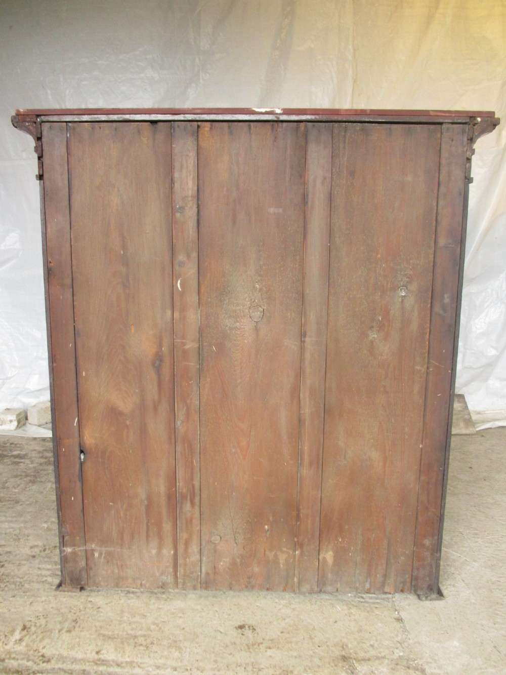 A Georgian flame mahogany two-door cabinet featuring fluted side pilasters, carved capitals, and prominent timber grain on the panelled doors. View VIII