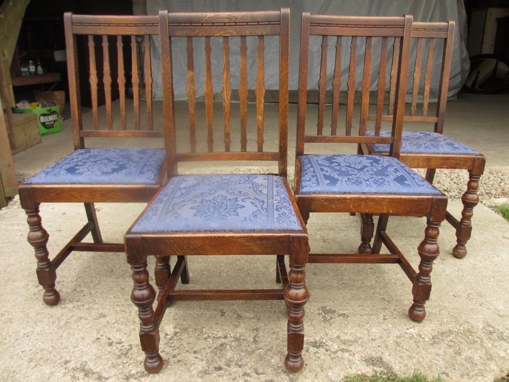 Four late 19th century oak slat back dining chairs 