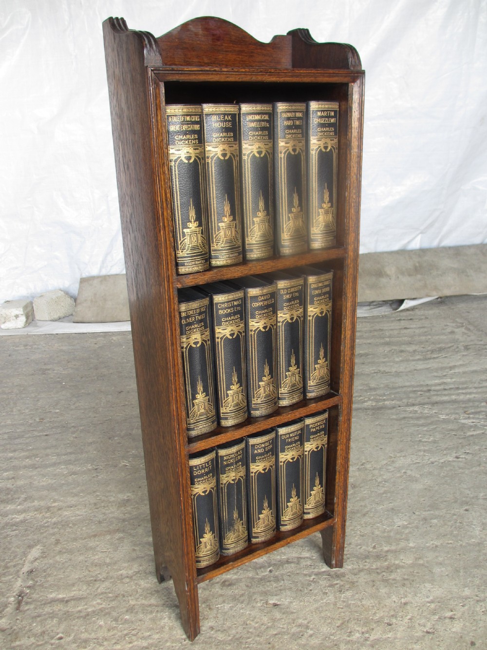 Edwardian slender oak bookcase with fifteen volumes of Dickens View X