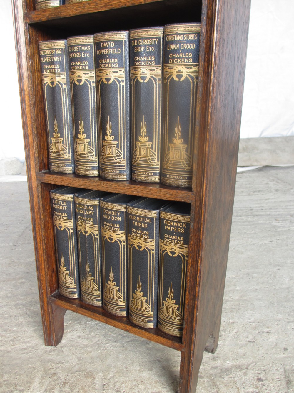 Edwardian slender oak bookcase with fifteen volumes of Dickens View XII