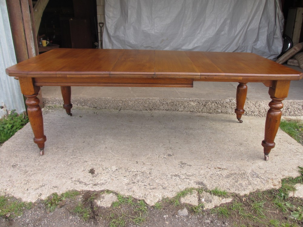 Victorian golden oak wind out extending dining table