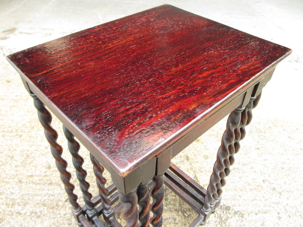 A nest of three dark oak square-topped side tables featuring carved barley twist legs and low stretchers. View III